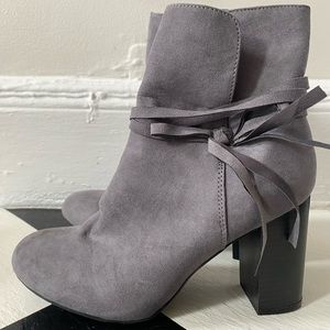 Grey booties with black heel and bow detail
